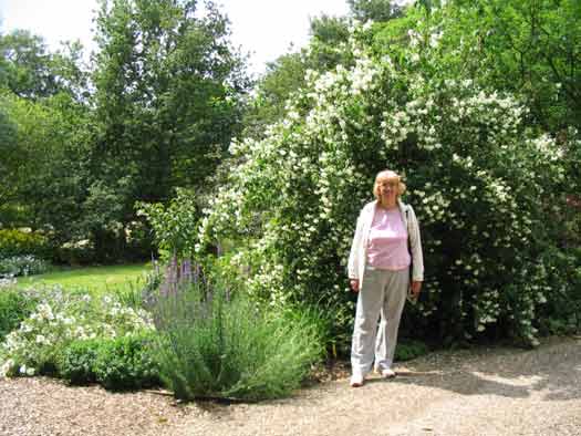 Pauline infront of Philadelphus or Orange Syringa bush